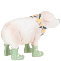 Produkt Dekoracyjna świnka w gumiakach – Zabawna figurka farmera z wieńcem kwiatowym 15,5 cm