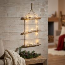 Produkt Świąteczna dekoracja ścienna z bajkowymi lampkami LED, małymi drewnianymi płatkami śniegu i pokrytymi śniegiem gałęziami. Wysokość 150 cm