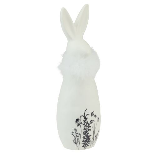 Produkt Ceramiczny króliczek w kolorze białym, ozdobne piórka, kwiaty Ø6cm W20,5cm
