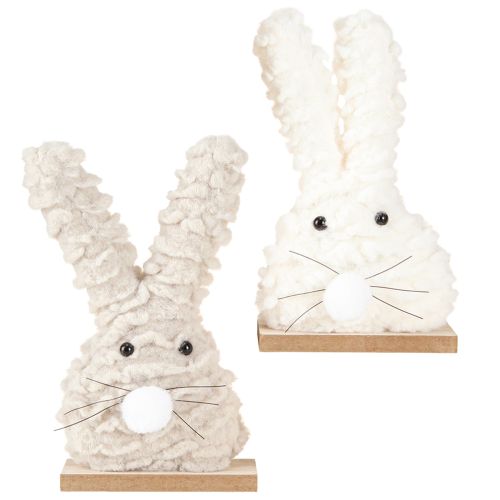 Produkt Dekoracyjny zając wielkanocny wykonany z pluszu – puszysta dekoracja wielkanocna w kolorze beżowo-białym na drewnianej podstawie wys. 18cm 2 szt.