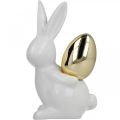 Floristik24 Króliki ze złotym jajkiem, ceramiczne króliki na wielkanoc szlachetne białe, złote W13cm 2szt